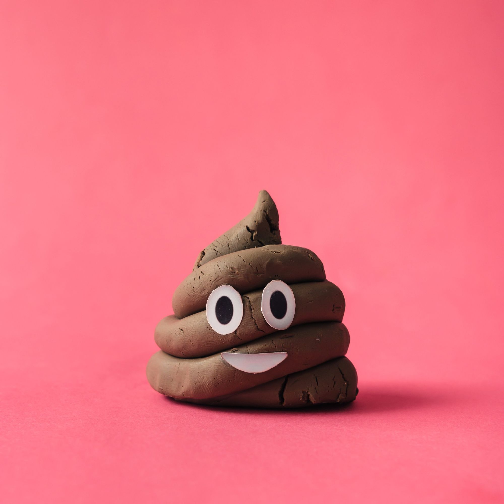 A clay sculpture of the poop emoji